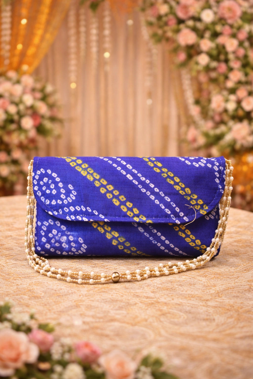Red and yellow Bandhej clutch bag with pearl sling, perfect for wedding functions and festive occasions