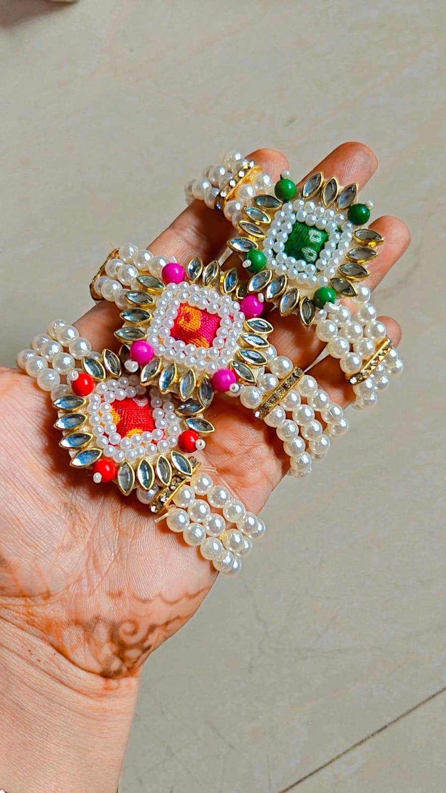 Bridal pearl kundan hand bracelet worn during haldi mehndi ceremony, elegant traditional jewelry for Indian wedding functions
