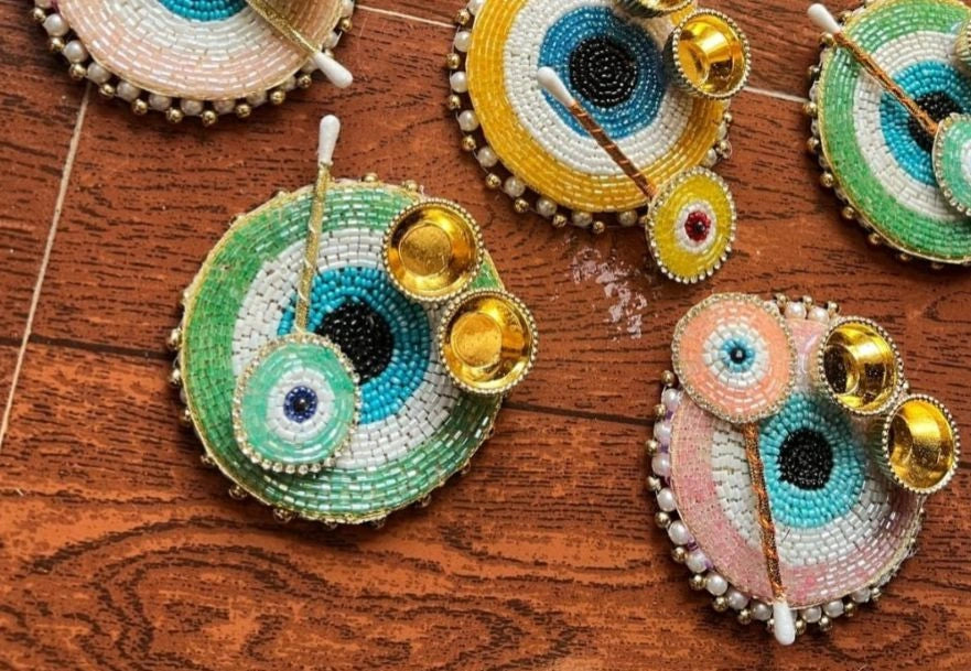 Handcrafted evil eye roli chawal platter used for puja, raksha bandhan and wedding rituals