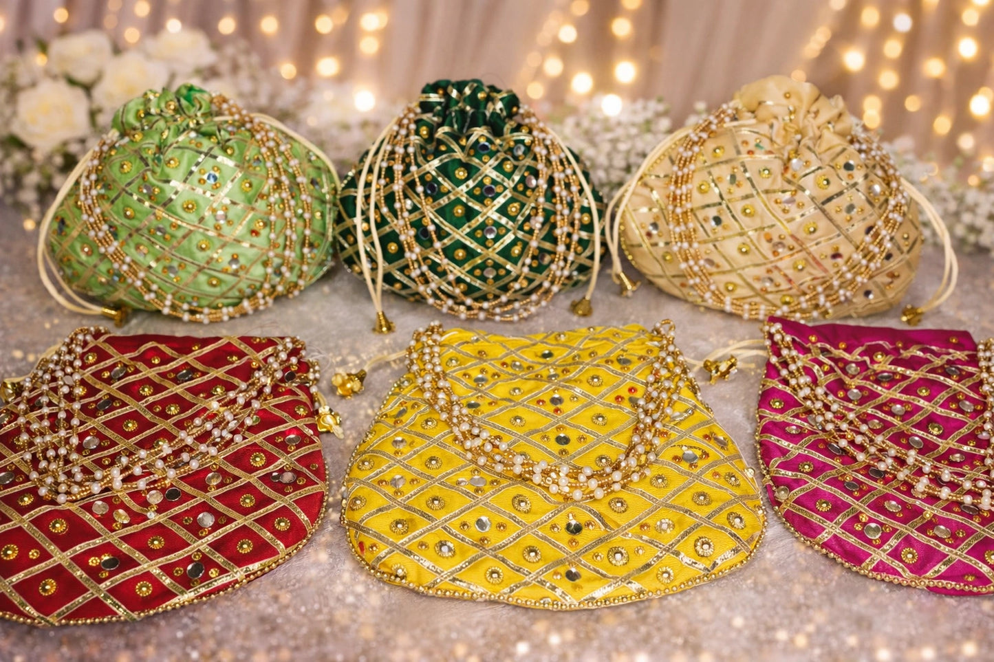 Beautiful handmade potli bag with traditional mirror work embroidery, perfect for wedding favors and festive gift packing.