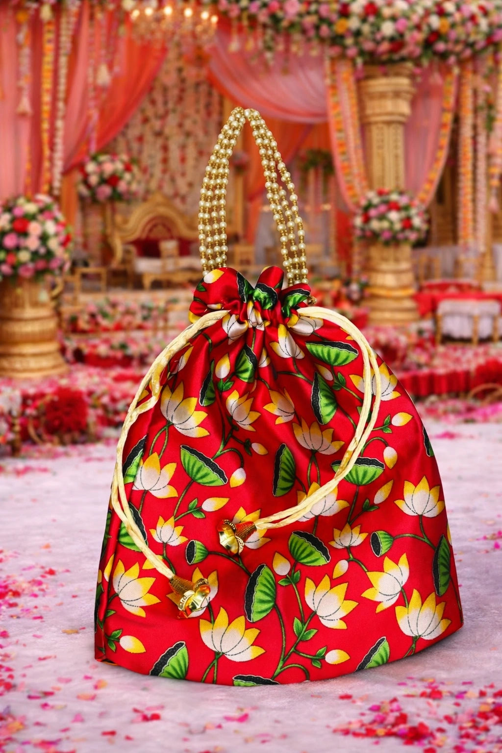 Designer wedding return gift potli bag in rich fabric with decorative tassels for guests