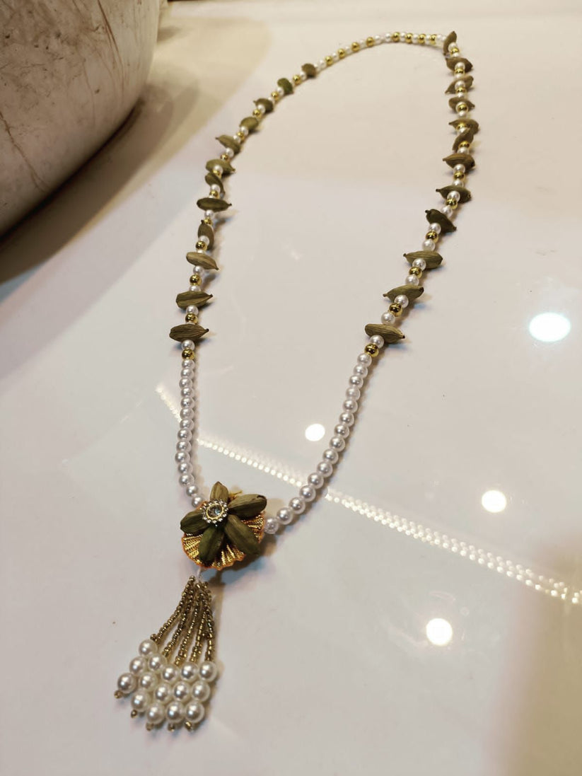 Bridal pearl necklace with decorative tassels and flower charm