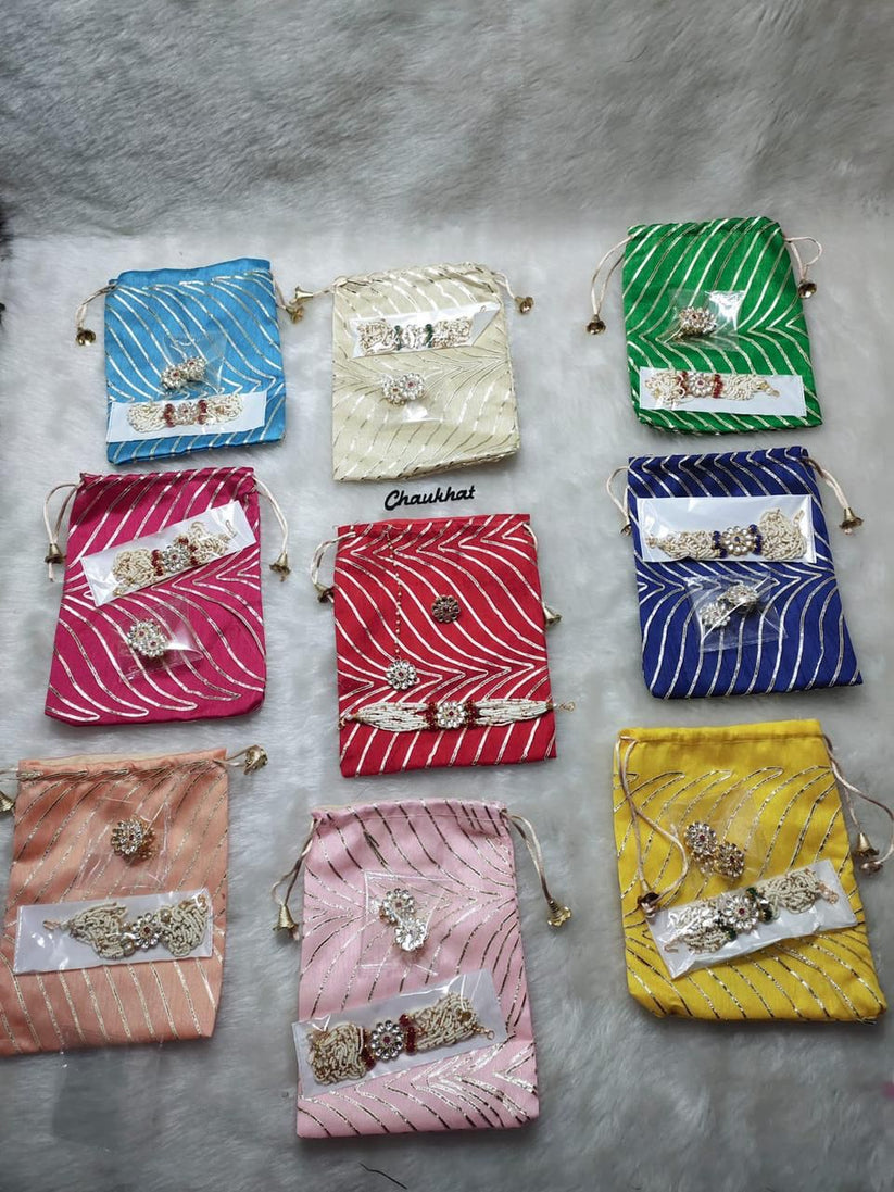 Colorful potli bag with matching bracelet teeka and ring for wedding return gift