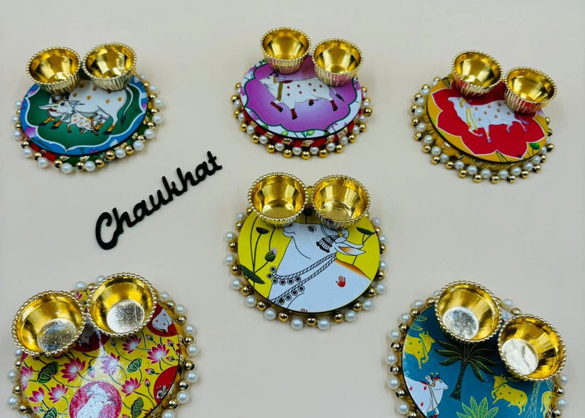 Decorative puja thali with Pichwai cow artwork for roli chawal and tilak ceremony