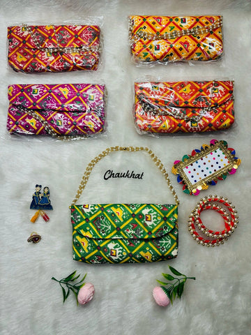 Designer Patola fabric clutch used for haldi kumkum, kangan and bindi ceremony in Indian wedding