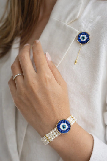 Evil eye pearl bracelet with matching nazar lapel pin designed for protection and stylish traditional outfits.