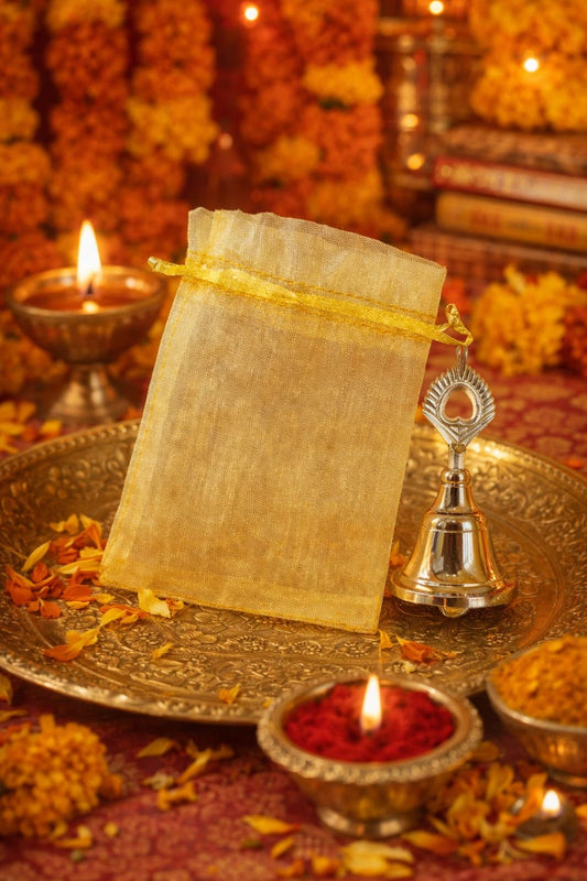 German silver pooja bell packed in decorative potli bag for religious rituals and gifting