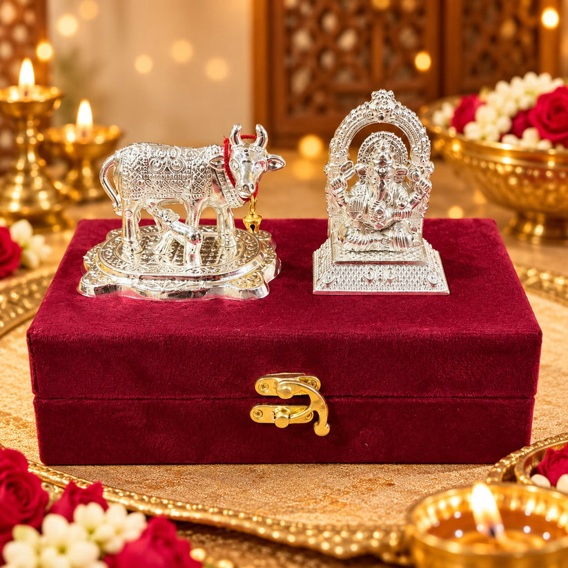 German silver cow and Ganesh Ji idol set displayed in a premium velvet gift box for Diwali gifting and home temple decoration.