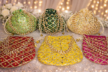 Beautiful handmade potli bag with traditional mirror work embroidery, perfect for wedding favors and festive gift packing.