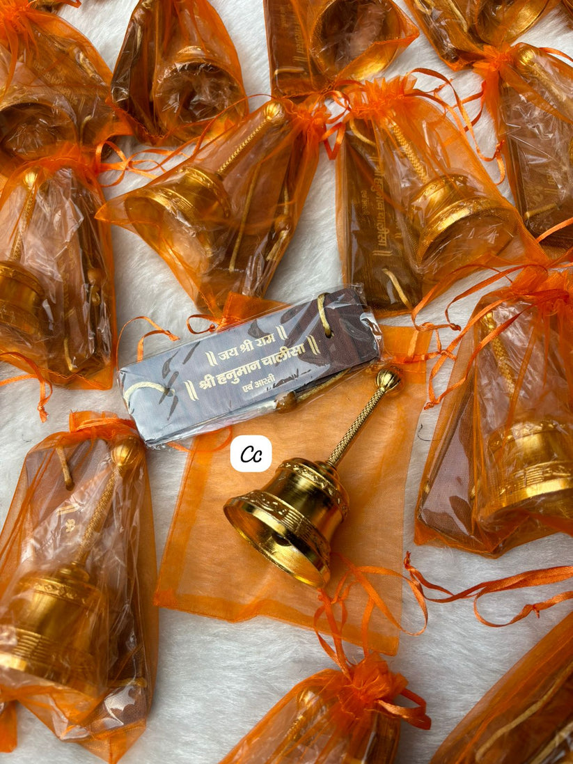 Hanuman Chalisa book and pooja bell arranged in decorative potli hamper for religious gifting