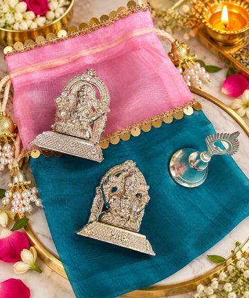 Laxmi Ganesh Diwali gift hamper with designer silk potli, decorative bell and pooja accessories