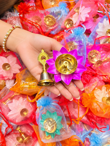 Lotus diya and decorative bell in potli for Diwali return gift and festive gifting