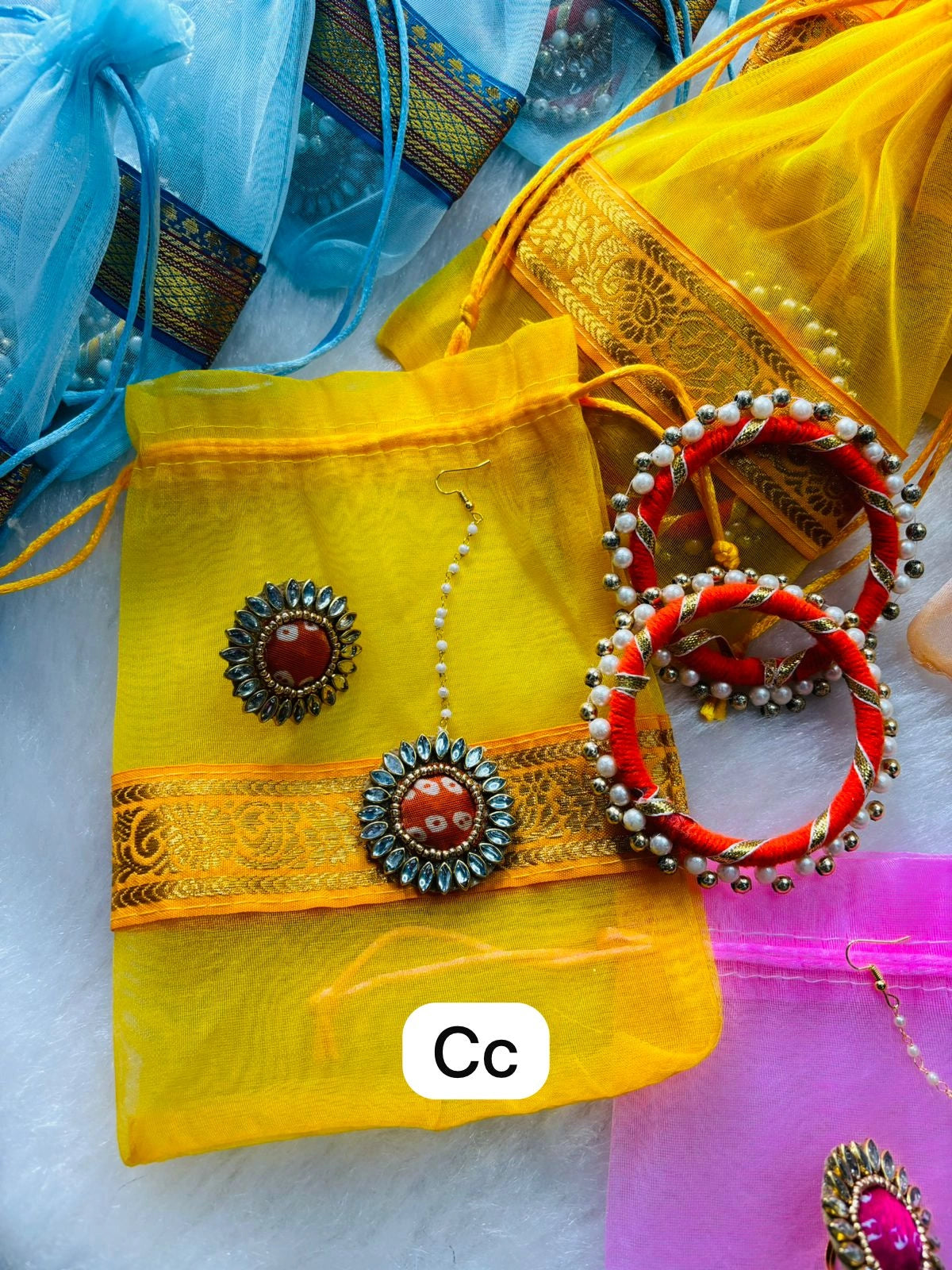 Wedding return gift mini hamper bag with maang tikka ring and kangan jewelry set for festive gifting