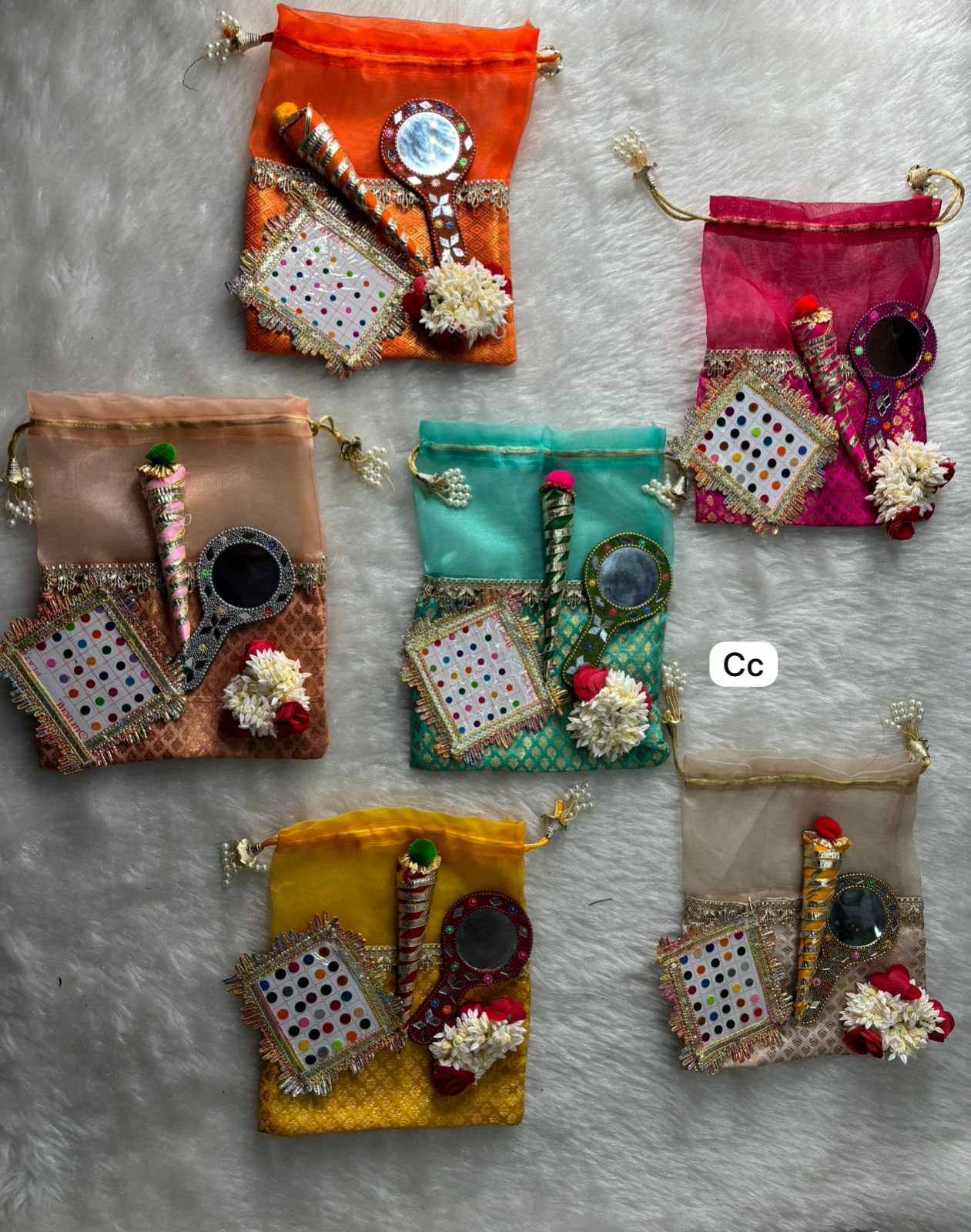 Wedding shringar potli bag set with mirror, bindi card and floral decor for bridal gifting