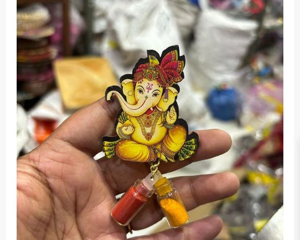 Ganesh Ji cutout with haldi kumkum bottles used as a traditional religious return gift