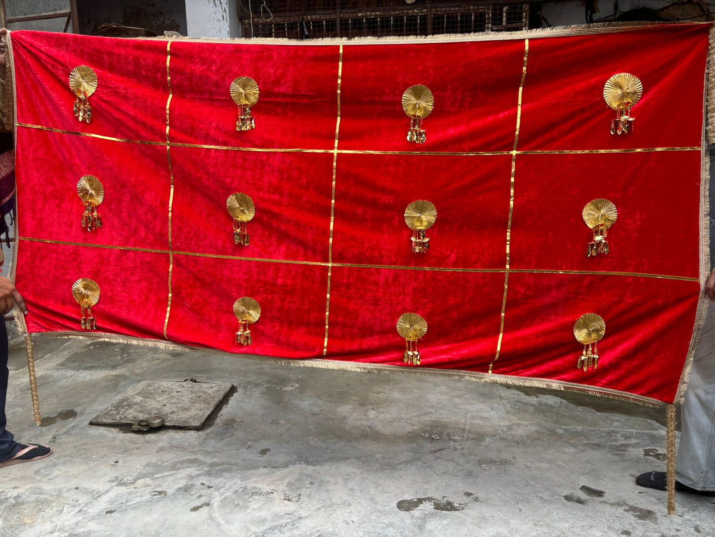 Royal red velvet bridal welcome chadar with golden latkans used for Indian wedding bridal entry backdrop